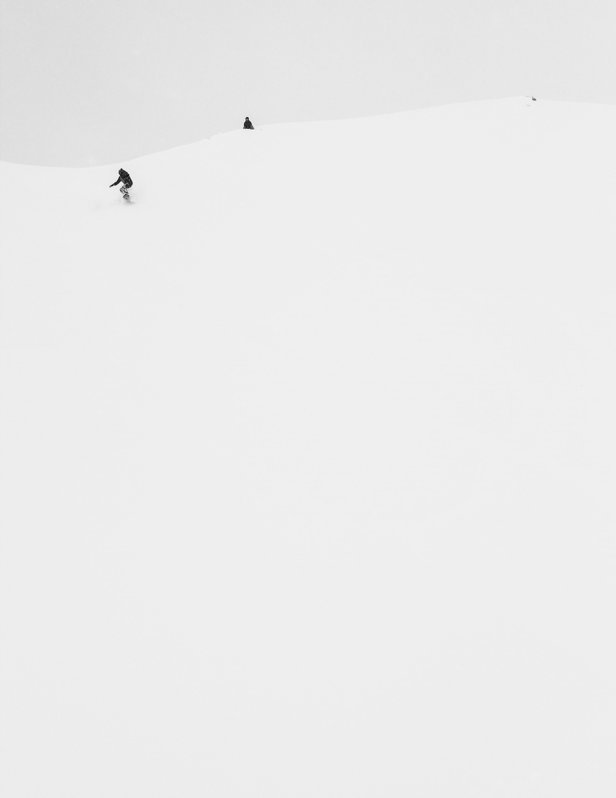 Snowboarder at the top of a hill