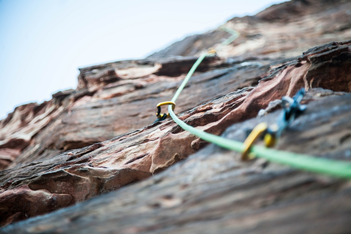 Climbing rope clipped to rock face