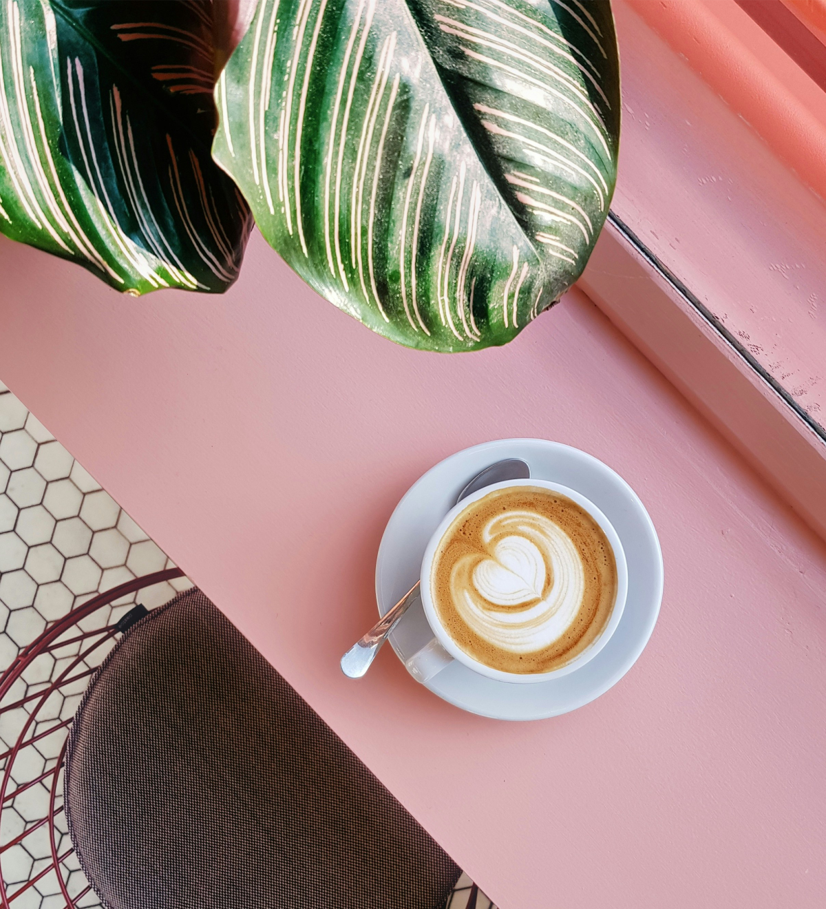 Coffee on a pink table.