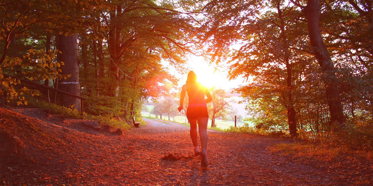 Person running with the sun in the background.