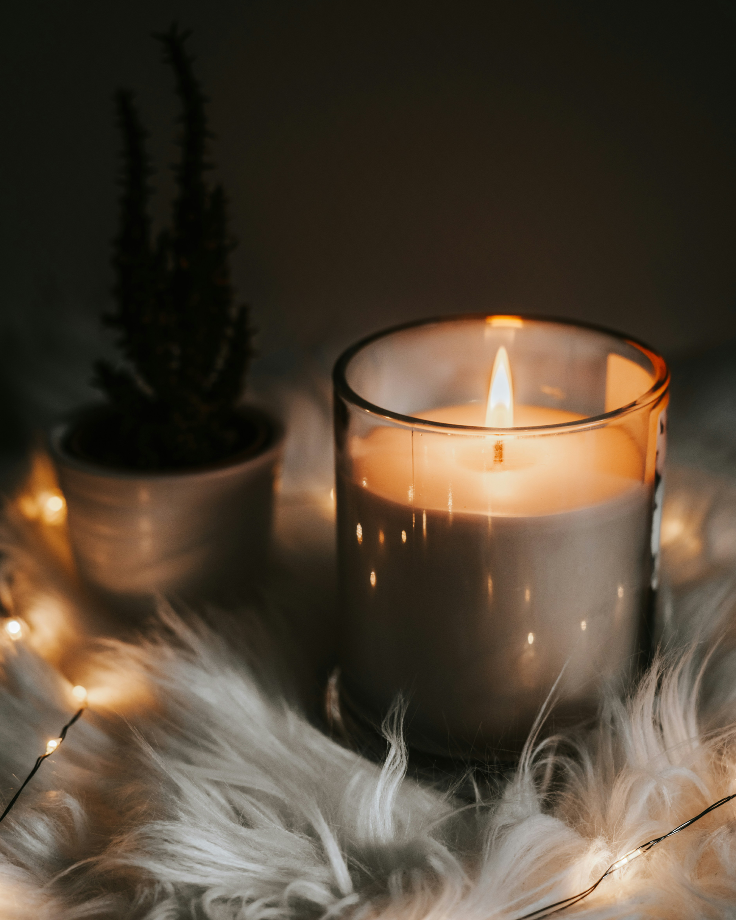 Candle on a fur rug.