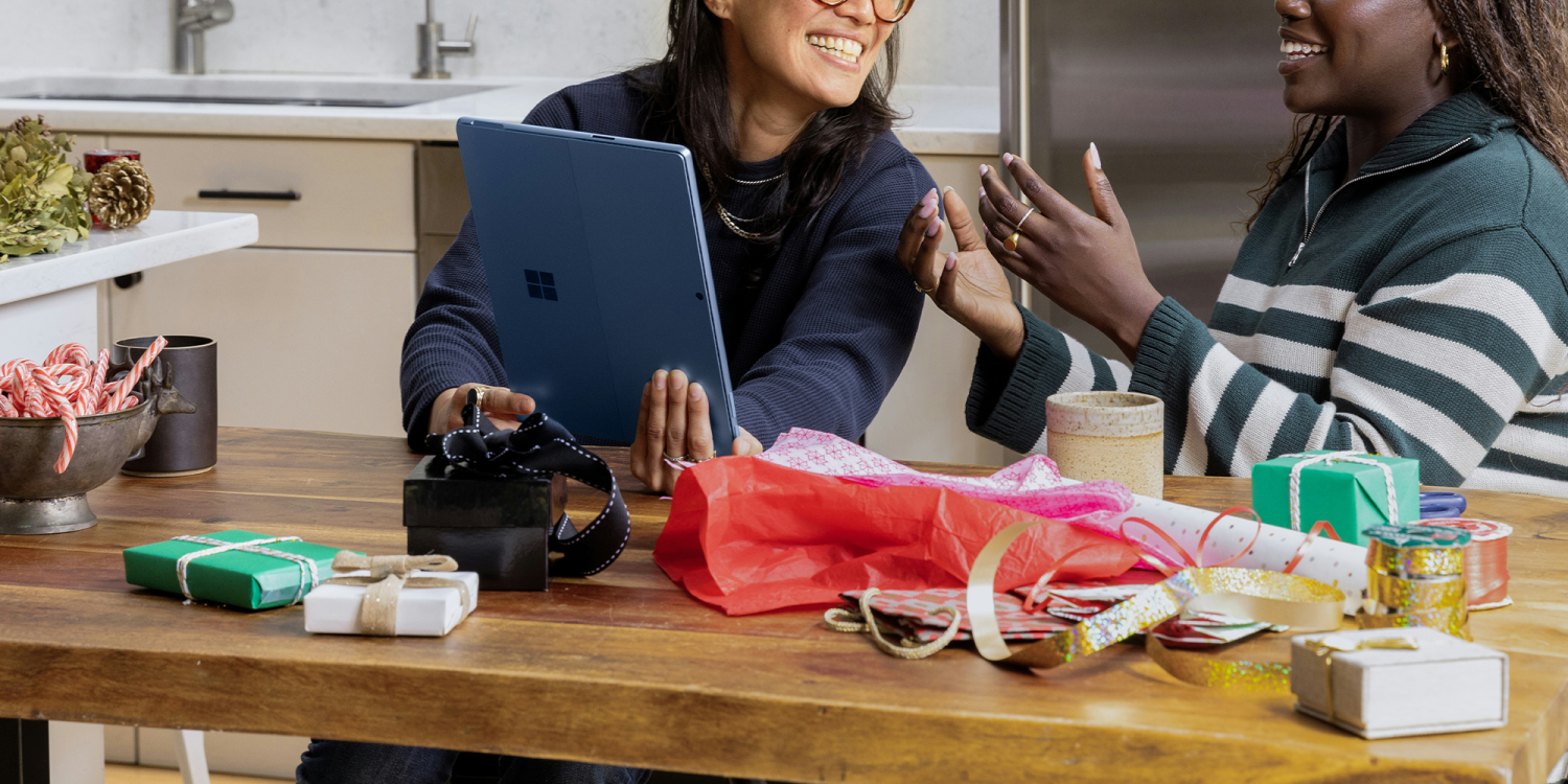 Image of two people sat together at a desk.