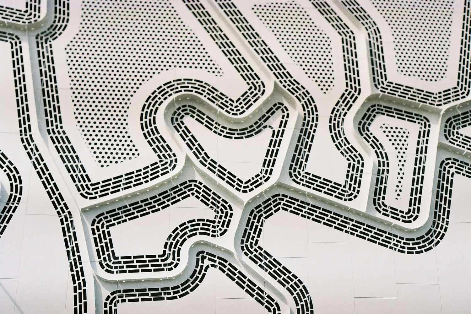 Birds eye view of a road in black and white imagery.