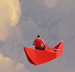 Paddling on paper boat in the clouds